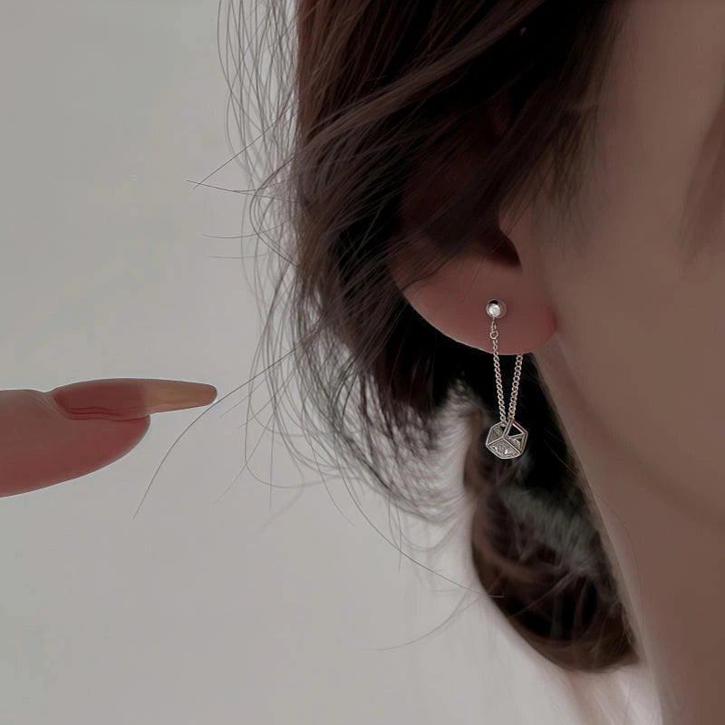 Model showcasing the dangle and style of the Sterling Silver Cube Diamond Zircon Earrings