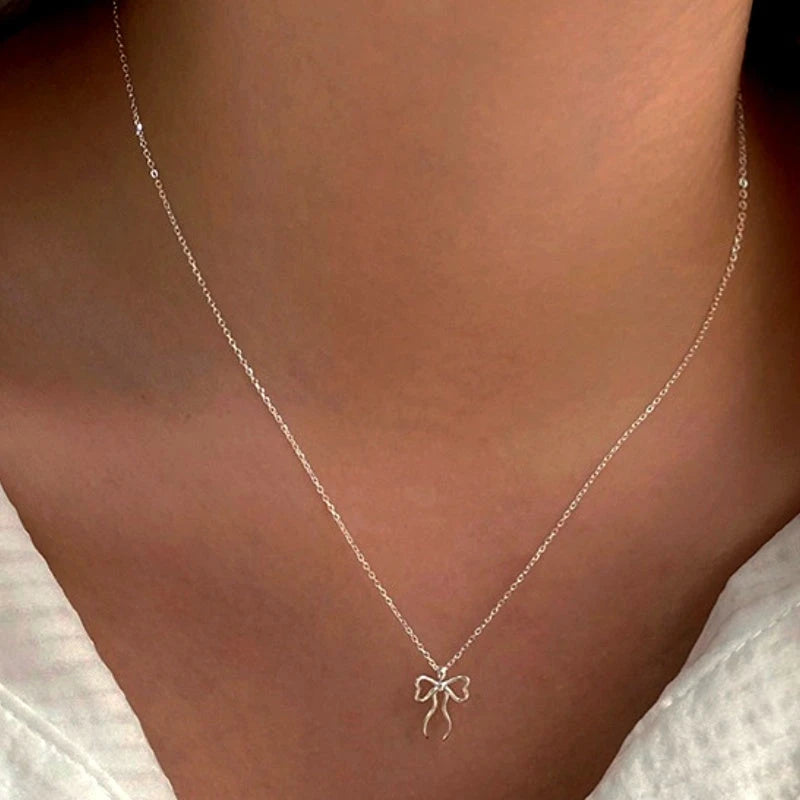 Sterling Silver Cute Simple Bow Necklace worn to showcase its length and pendant detail