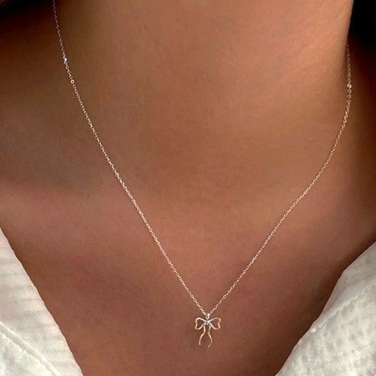 Sterling Silver Cute Simple Bow Necklace worn to showcase its length and pendant detail
