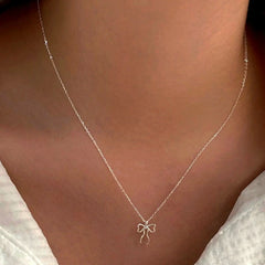 Sterling Silver Cute Simple Bow Necklace worn to showcase its length and pendant detail