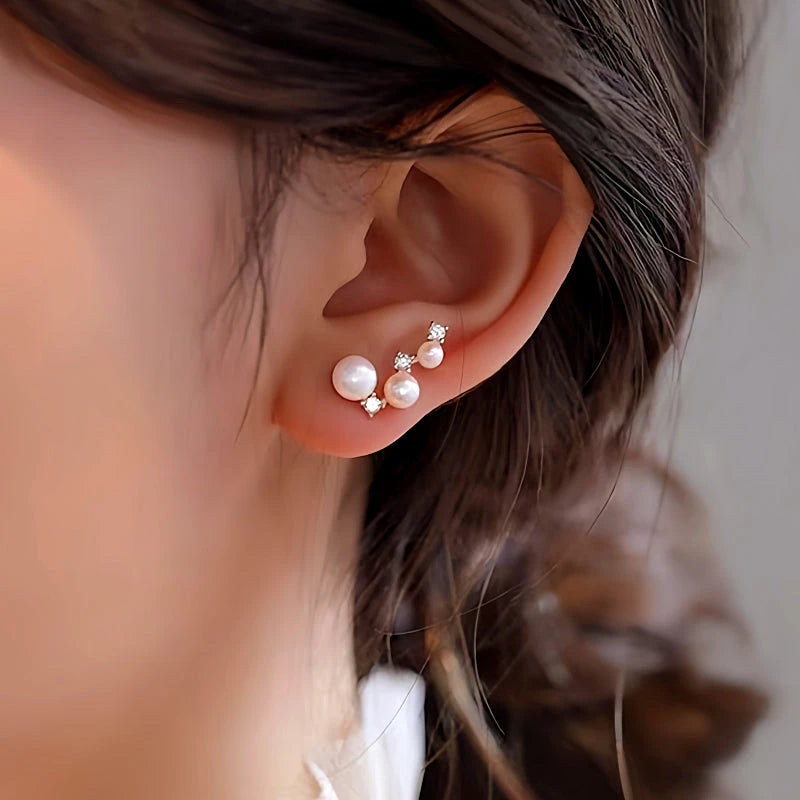 Model showcasing the dangle and style of the Sterling Silver Diamond And Pearl Stud Earrings
