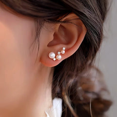 Model showcasing the dangle and style of the Sterling Silver Diamond And Pearl Stud Earrings