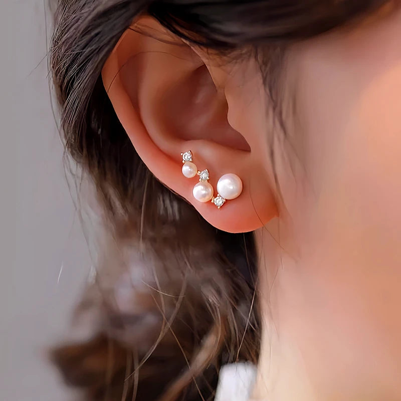 Angled view of the Sterling Silver Diamond And Pearl Stud Earrings