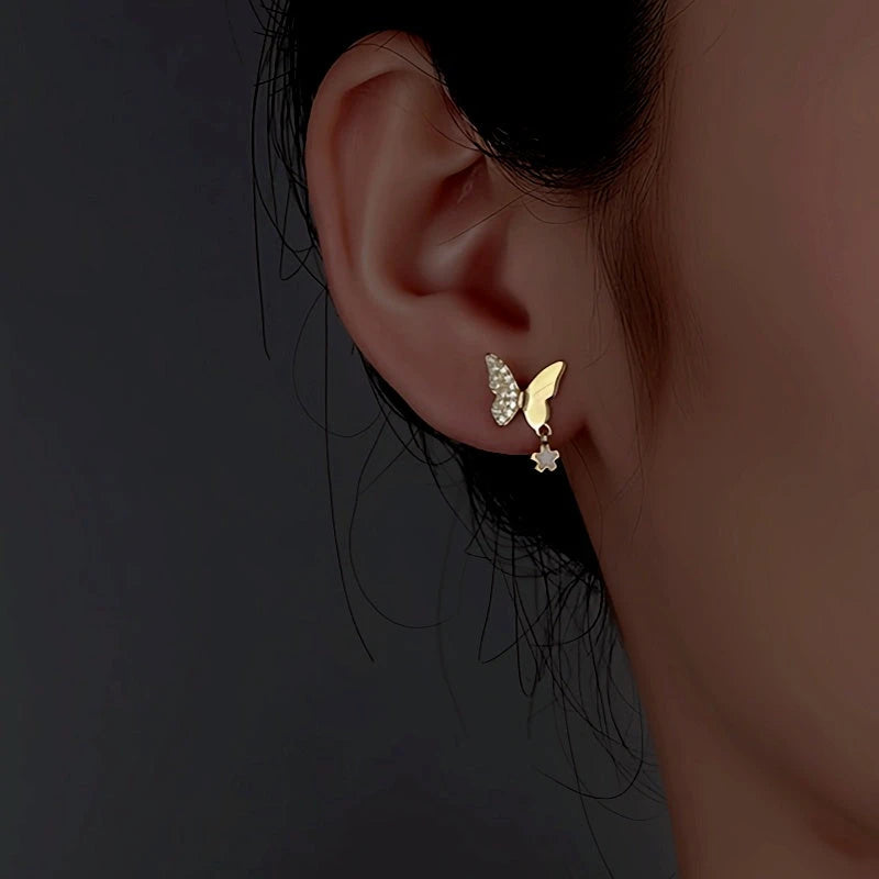 Model showcasing the dangle and style of the Sterling Silver Diamond Butterfly Earrings