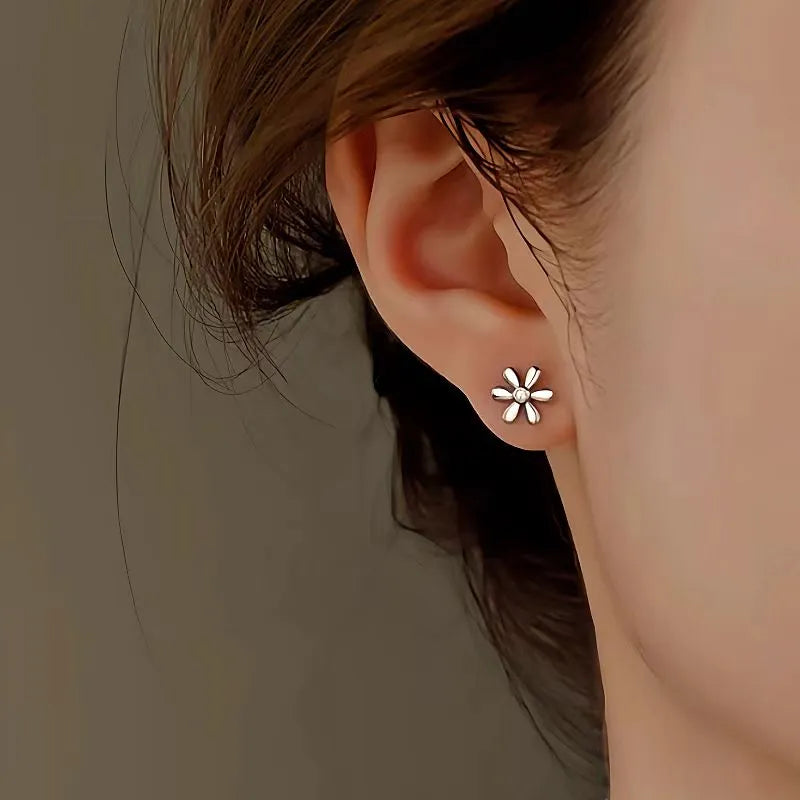 Model showcasing the dangle and style of the Sterling Silver Diamond Daisy Stud Earrings