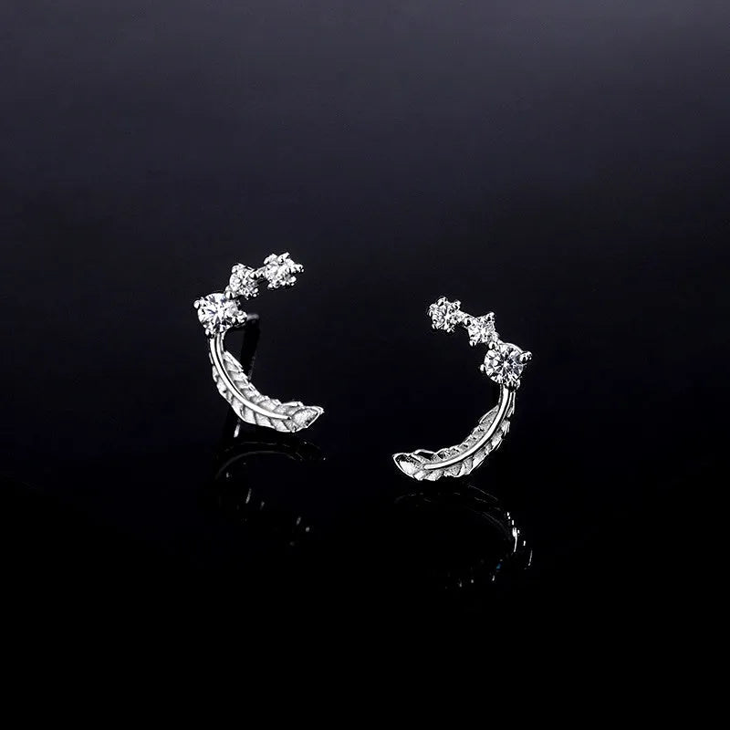 Model showcasing the dangle and style of the Sterling Silver Diamond Feather Stud Earrings