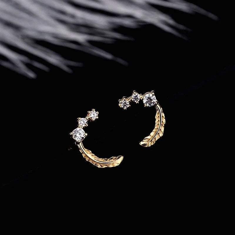 Close-up detail of the sparkling zircons and plating on the Feather Stud Earrings