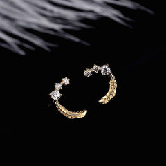 Close-up detail of the sparkling zircons and plating on the Feather Stud Earrings