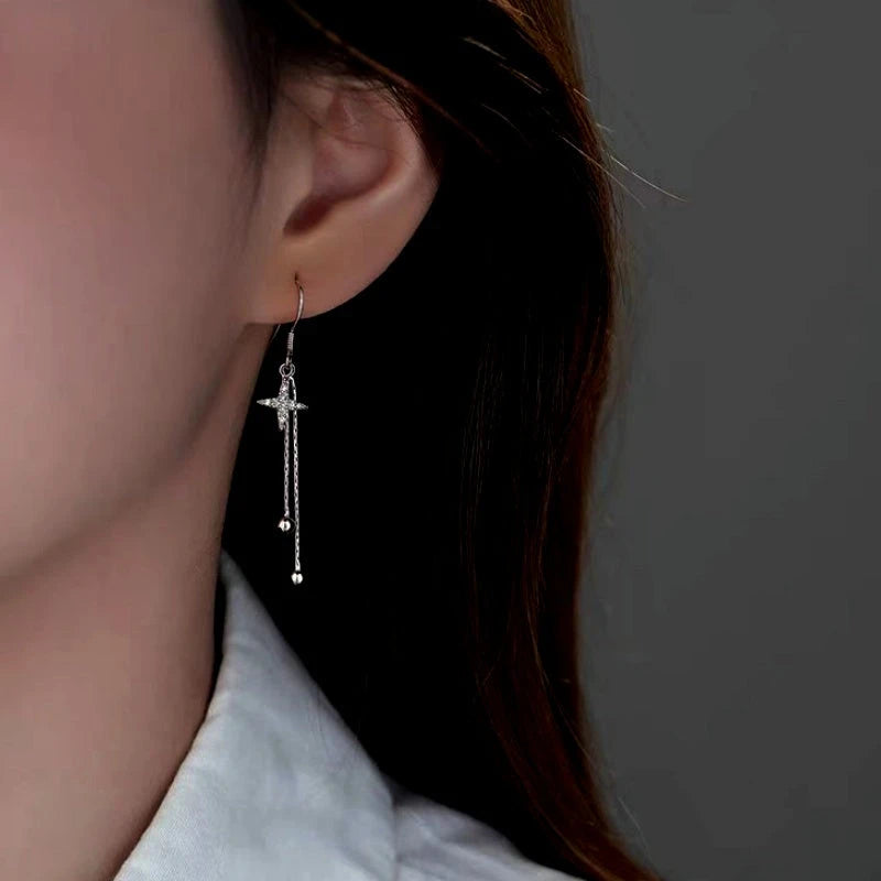 Model showcasing the dangle and style of the Sterling Silver Diamond Four-Pointed Star Bamboo Tassel Ear Hooks