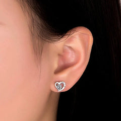 Model showcasing the dangle and style of the Sterling Silver Diamond Heart Stud Earrings