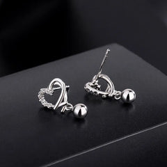 Angled view of the Sterling Silver Diamond Hollow Heart Bean Earrings