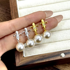 Model showcasing the dangle and style of the Sterling Silver Diamond Iris Imitation Pearl Earrings