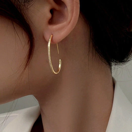 Model showcasing the dangle and style of the Sterling Silver Diamond Line C-Shaped Earrings