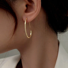 Model showcasing the dangle and style of the Sterling Silver Diamond Line C-Shaped Earrings