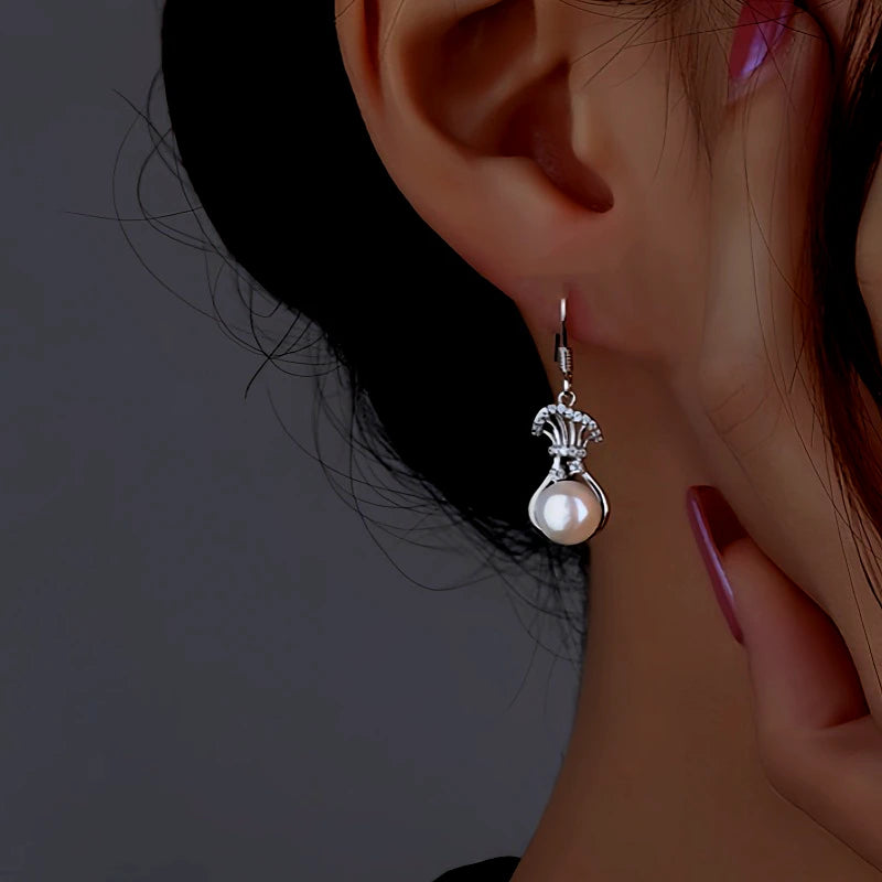 Angled view of the Sterling Silver Diamond Lucky Bag Pearl Ear Hooks