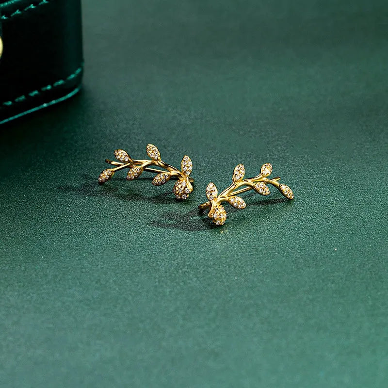 Model showcasing the dangle and style of the Sterling Silver Diamond Olive Branch Earrings