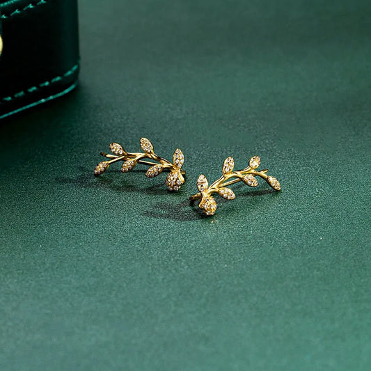 Model showcasing the dangle and style of the Sterling Silver Diamond Olive Branch Earrings