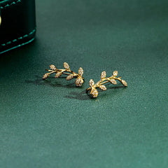 Model showcasing the dangle and style of the Sterling Silver Diamond Olive Branch Earrings