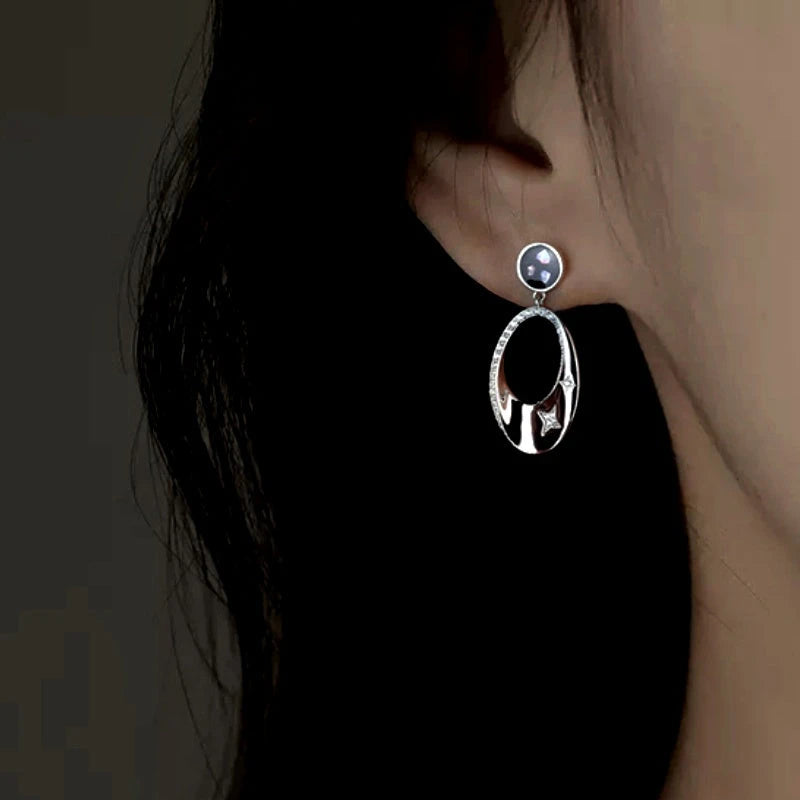 Model showcasing the dangle and style of the Sterling Silver Diamond Oval Earrings