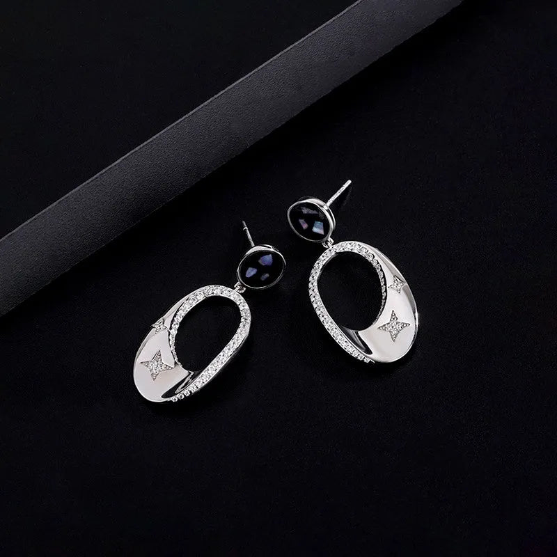 Close-up detail of the sparkling zircons and plating on the Star Tassel Ear Hooks