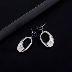 Close-up detail of the sparkling zircons and plating on the Star Tassel Ear Hooks