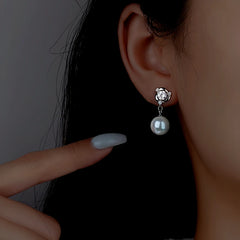 Model showcasing the dangle and style of the Sterling Silver Diamond Pearl Earrings