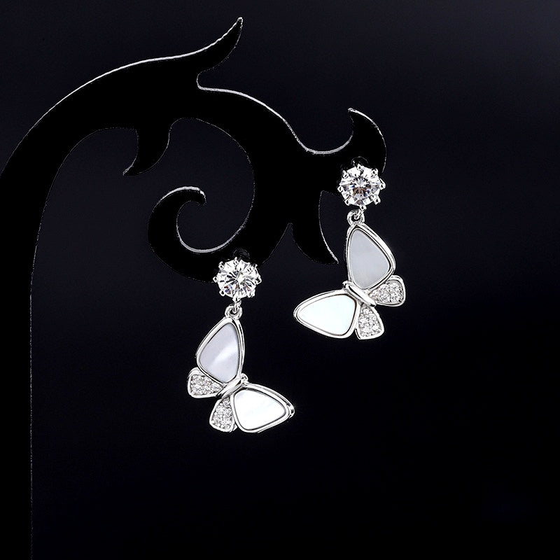 Model showcasing the dangle and style of the Sterling Silver Diamond Shell Butterfly Earrings