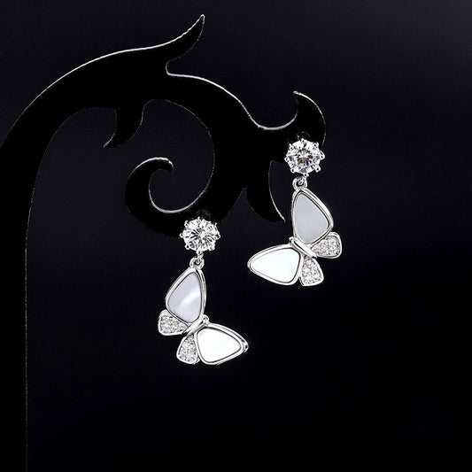 Model showcasing the dangle and style of the Sterling Silver Diamond Shell Butterfly Earrings