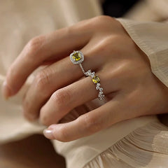 Top-down view of the sparkling Sterling Silver Diamonds And Olive Green Zircon Rings
