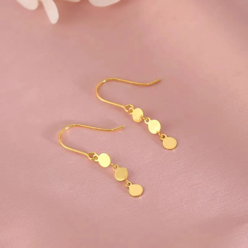 Model showcasing the dangle and style of the Sterling Silver Disc Ear Hook Earrings