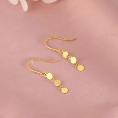 Model showcasing the dangle and style of the Sterling Silver Disc Ear Hook Earrings