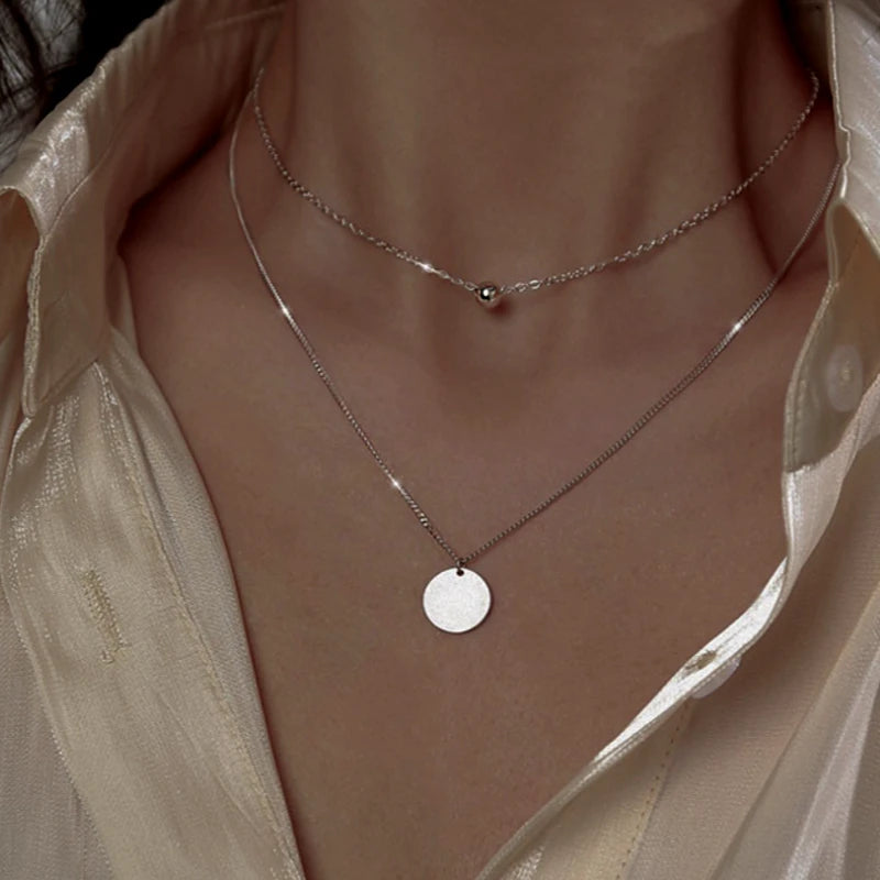 Close-up of the pendant and clasp on the Double Ball Earrings