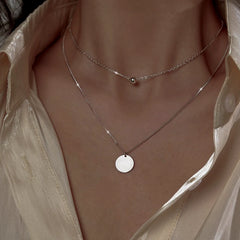 Close-up of the pendant and clasp on the Double Ball Earrings