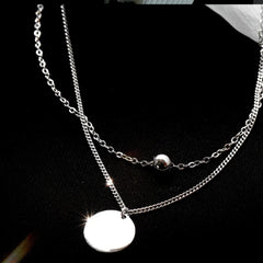 Sterling Silver Double-Layer Disc Necklace worn to showcase its length and pendant detail
