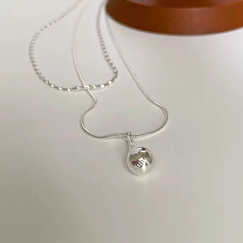 Close-up of the pendant and clasp on the Butterfly Pearl Earrings