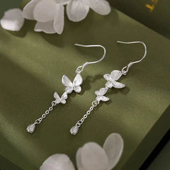 Angled view of the Sterling Silver Double Butterfly Ear Hook Tassel Earrings