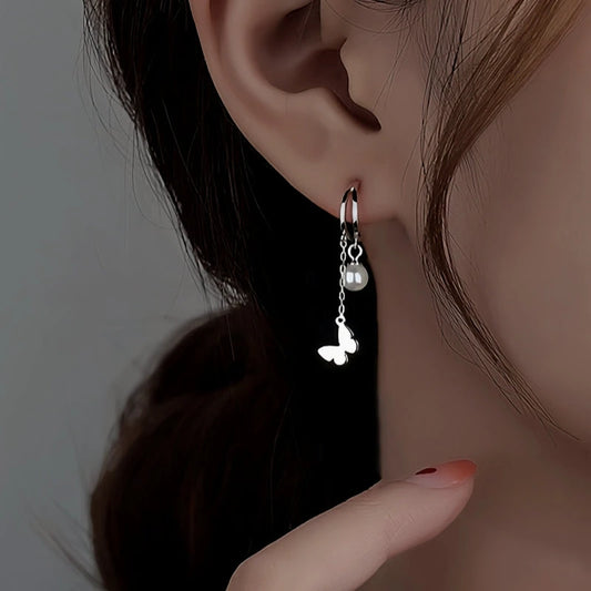 Model showcasing the dangle and style of the Sterling Silver Double Later Butterfly Pearl Earrings