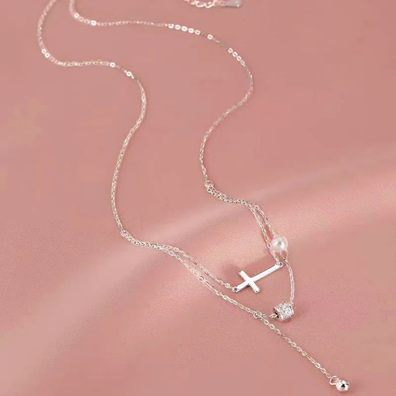 Sterling Silver Double Layer Stacked Cross Pearl Necklaces worn to showcase its length and pendant detail