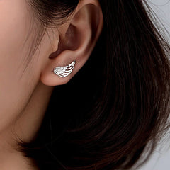 Model showcasing the dangle and style of the Sterling Silver Elegant Angel Wing Crawler Earrings