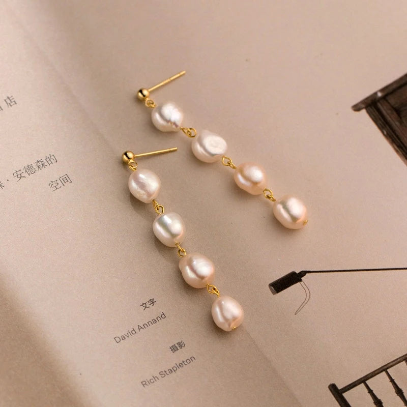 Model showcasing the dangle and style of the Sterling Silver Elegant Baroque Pearl Tassel Earrings