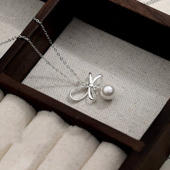 Detailed view of the Sterling Silver Elegant Bow Pearl Necklace chain and pendant
