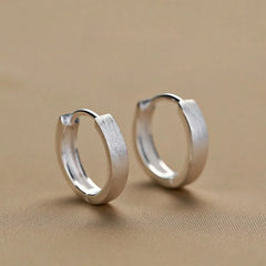 Close-up detail of the sparkling zircons and plating on the Double Hoop Earrings