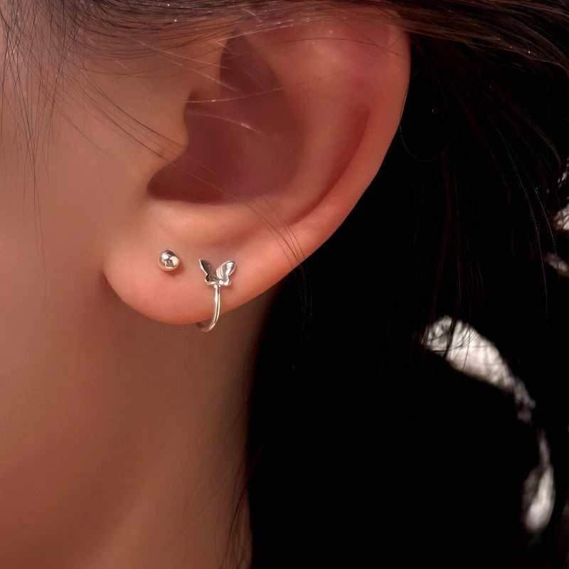 Model showcasing the dangle and style of the Sterling Silver Elegant Butterfly Earrings