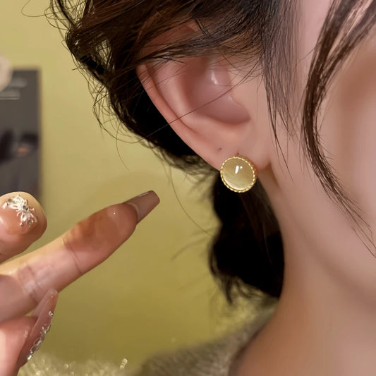 Model showcasing the dangle and style of the 14K Gold-Plated  Elegant Cat's Eye Stone Hoop Earrings