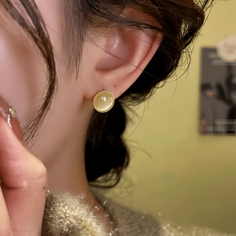 Close-up detail of the sparkling zircons and plating on the gold hoop earrings