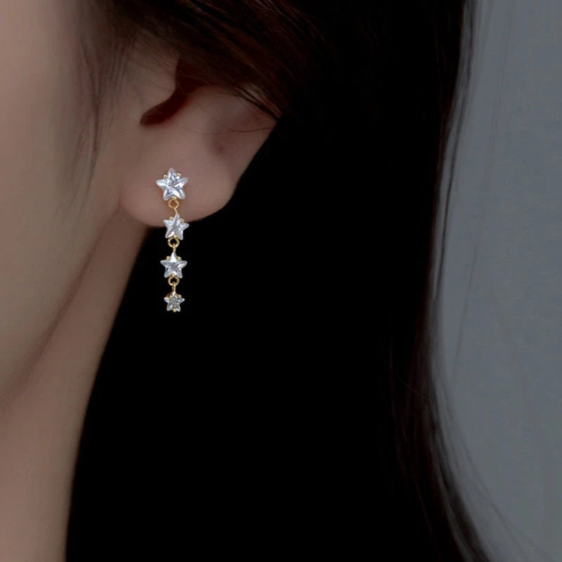 Model showcasing the dangle and style of the Sterling Silver Elegant Crystal Star Tassel Earrings