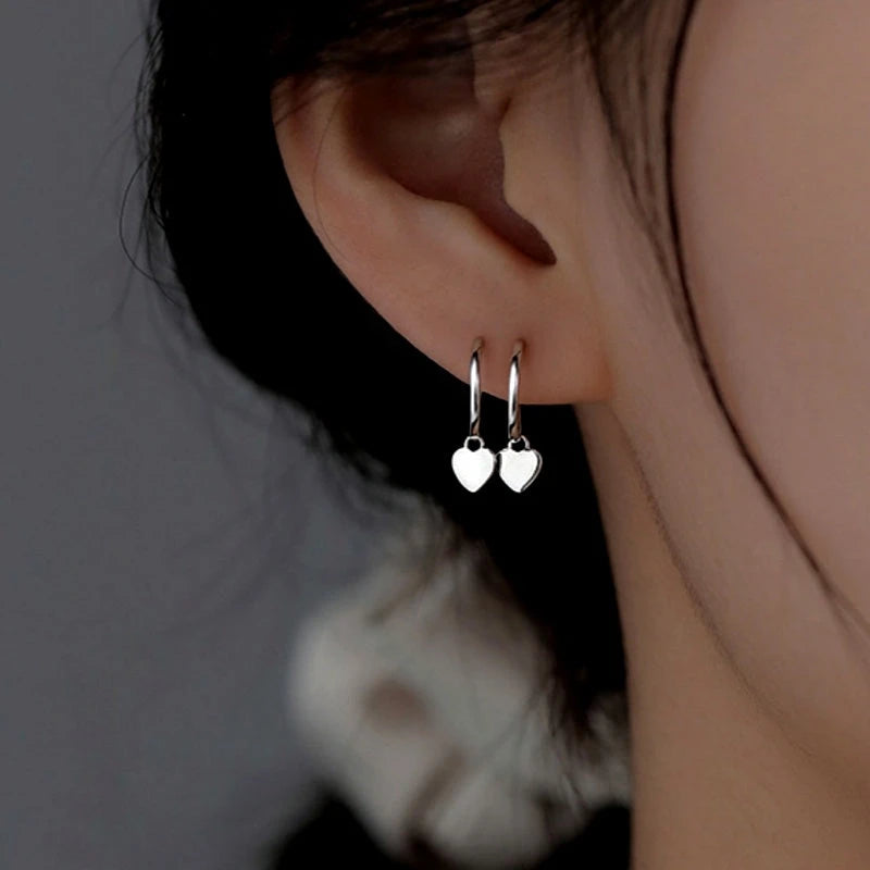 Close-up detail of the sparkling zircons and plating on the Asymmetrical Heart Earrings