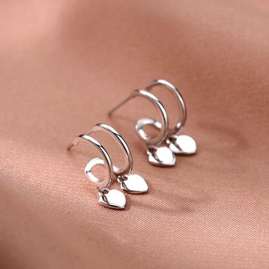 Model showcasing the dangle and style of the Sterling Silver Elegant Double-Layer Heart Earrings