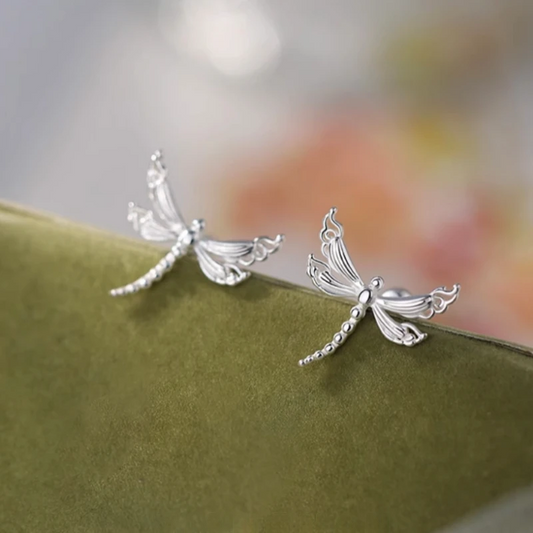 Model showcasing the dangle and style of the Sterling Silver Elegant Dragonfly Stud Earrings