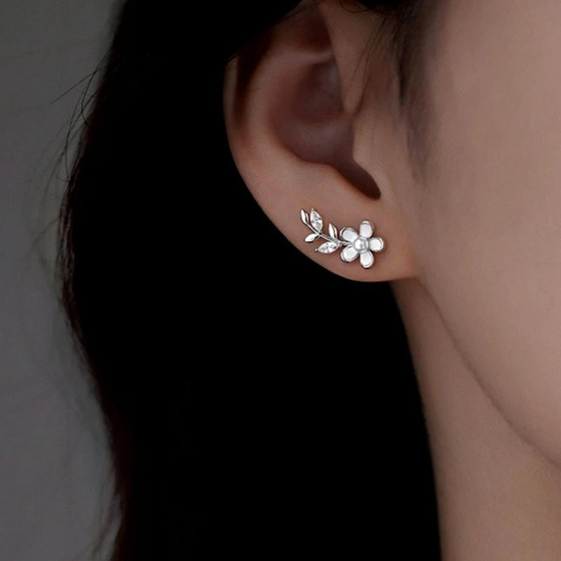 Model showcasing the dangle and style of the Sterling Silver Elegant Flower Stud Earrings